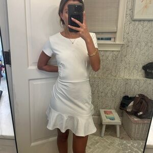 White mini dress with ruffle bottom